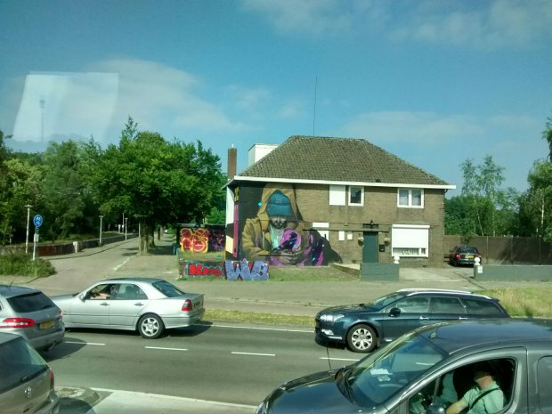 Graffiti painted on the wall of a brick house. 