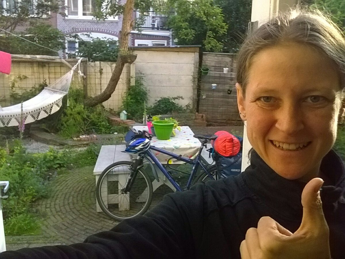 Me showing thumbs up with bike and garden in the background.